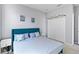 Relaxing bedroom featuring a blue upholstered headboard, side tables, and a double door closet at 3121 Buffington Pl, Oviedo, FL 32765