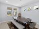 Bright dining room with large windows, modern table, bench, and stylish decor at 3121 Buffington Pl, Oviedo, FL 32765