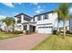 Charming two-story home with a spacious balcony, two-car garage, manicured lawn and brick-paved driveway at 3121 Buffington Pl, Oviedo, FL 32765
