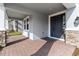 Charming covered front porch with brick pavers and a modern gray front door with side windows at 3121 Buffington Pl, Oviedo, FL 32765