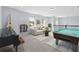 Recreational room featuring a sofa, piano, billiards table, and natural light at 3121 Buffington Pl, Oviedo, FL 32765