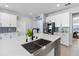 Kitchen island boasts a stainless steel sink, modern faucet, and ample counter space at 3121 Buffington Pl, Oviedo, FL 32765