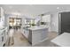 Bright kitchen with a spacious island, stainless steel appliances, and an open layout to the dining area at 3121 Buffington Pl, Oviedo, FL 32765