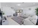 A large living room featuring a sectional sofa, a gray rug and an open view to the kitchen at 3121 Buffington Pl, Oviedo, FL 32765