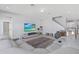 Spacious living room featuring comfortable seating, a large TV, and access to the staircase at 3121 Buffington Pl, Oviedo, FL 32765