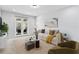 Bright living room featuring a comfortable sofa, modern decor, and access to a balcony at 3121 Buffington Pl, Oviedo, FL 32765