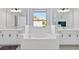 Luxurious main bathroom featuring a soaking tub, double vanities, and elegant fixtures at 3121 Buffington Pl, Oviedo, FL 32765