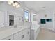 Bright main bathroom with double sinks, a soaking tub, and a separate shower area at 3121 Buffington Pl, Oviedo, FL 32765