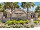Stone sign for Hideaway Cove at Oviedo with lush landscaping and palm trees at 3121 Buffington Pl, Oviedo, FL 32765