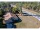 Aerial view of a single-Gathering home near a highway, showcasing a well-maintained lawn and mature trees at 3199 Quail Dr, Deltona, FL 32738