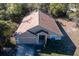 Aerial view of a cozy single-Gathering home that features a two-car garage and a well-maintained lawn at 3199 Quail Dr, Deltona, FL 32738