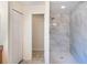 Modern bathroom showcasing walk-in shower with floor-to-ceiling marble style tile at 3199 Quail Dr, Deltona, FL 32738