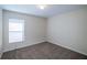 Carpeted bedroom with natural light from a window, providing a serene and peaceful retreat at 3199 Quail Dr, Deltona, FL 32738