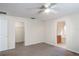 A bright bedroom with carpet and a ceiling fan with en suite bathroom and walk-in closet at 3199 Quail Dr, Deltona, FL 32738