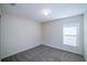 Neutral bedroom with carpet, a window, and a simple design that offers a cozy, blank canvas at 3199 Quail Dr, Deltona, FL 32738