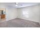 Spacious carpeted bedroom with natural light and neutral tones, connecting to a full bathroom at 3199 Quail Dr, Deltona, FL 32738