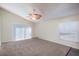 Large living room with vaulted ceiling, carpet, and a large sliding glass door at 3199 Quail Dr, Deltona, FL 32738