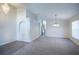 Bright living room with gray carpet, an archway, and modern chandeliers creating an inviting atmosphere at 3199 Quail Dr, Deltona, FL 32738