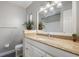 Bathroom vanity featuring neutral counters, potted plants and a large framed mirror at 3214 Debbie Dr, Orlando, FL 32806