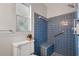 Bathroom shower featuring blue tile and grab bars at 3214 Debbie Dr, Orlando, FL 32806