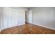 Empty bedroom with parquet flooring and closet space at 3214 Debbie Dr, Orlando, FL 32806