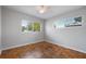 Bright bedroom with parquet floors, fan, and large, sunny windows at 3214 Debbie Dr, Orlando, FL 32806