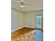 The bedroom features parquet floors, fan, and a glass patio door leading to outdoor space at 3214 Debbie Dr, Orlando, FL 32806