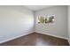 Simple bedroom with wood floors and a window overlooking the yard at 3214 Debbie Dr, Orlando, FL 32806