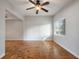 An empty bedroom with parquet flooring, a ceiling fan, and lots of natural light at 3214 Debbie Dr, Orlando, FL 32806