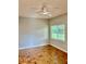 Cozy bedroom with parquet floors, a ceiling fan, and a window for natural light at 3214 Debbie Dr, Orlando, FL 32806