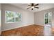 Bright bedroom features a ceiling fan, wood floors, and a window providing natural light at 3214 Debbie Dr, Orlando, FL 32806