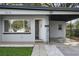Inviting front porch with a bright white door, decorative stone accents, and a convenient carport entrance at 3214 Debbie Dr, Orlando, FL 32806
