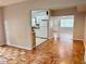 Spacious living room view into kitchen with parquet floors and bright light at 3214 Debbie Dr, Orlando, FL 32806