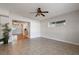 Inviting living area with neutral tile flooring and seamless transition to a dining space with hardwood floors at 3214 Debbie Dr, Orlando, FL 32806