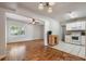 Charming home featuring a cozy living room seamlessly connected to a functional kitchen with white appliances at 3214 Debbie Dr, Orlando, FL 32806