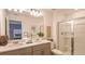 Elegant bathroom with dual vanities, a glass-enclosed shower, and modern fixtures for a spa-like experience at 3550 Mayfair St, Kissimmee, FL 34758