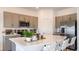Stylish kitchen features stainless steel appliances, stone countertops and a large central island at 3550 Mayfair St, Kissimmee, FL 34758