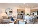 Open living space featuring modern furniture, kitchen view, and natural light for versatile use at 3550 Mayfair St, Kissimmee, FL 34758