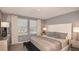 Comfortable bedroom with neutral tones, large windows, and elegant furnishings for a peaceful retreat at 3550 Mayfair St, Kissimmee, FL 34758