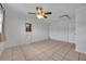 Bedroom features tile flooring, a ceiling fan, and a built-in display shelf at 397 Oslo Dr, Deltona, FL 32725