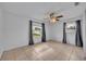 A bedroom features tile flooring, gray curtains, and two windows with backyard views at 397 Oslo Dr, Deltona, FL 32725