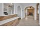 Open entryway showcasing brick accents, tile flooring, and views into the kitchen and living room at 397 Oslo Dr, Deltona, FL 32725