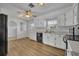 Bright kitchen with white cabinets, stainless steel appliances, and hardwood flooring at 397 Oslo Dr, Deltona, FL 32725