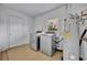 Bright laundry room with modern washer, dryer, and water heater at 397 Oslo Dr, Deltona, FL 32725