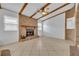 Inviting living room featuring a brick fireplace, exposed beams, and ample natural light at 397 Oslo Dr, Deltona, FL 32725