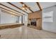 Bright living room with a brick fireplace, tiled floors, and exposed ceiling beams at 397 Oslo Dr, Deltona, FL 32725