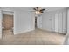 Main bedroom featuring tile flooring, a ceiling fan, and an ensuite bathroom and walk-in closet at 397 Oslo Dr, Deltona, FL 32725