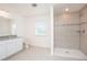 Bathroom featuring a tiled shower and a vanity with granite countertops at 4152 Sagefield Dr, Harmony, FL 34773