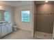 Well-lit bathroom features a granite countertop, tile flooring, and a tiled walk-in shower at 4152 Sagefield Dr, Harmony, FL 34773