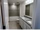 Bathroom featuring granite countertop, double sink vanity, tiled floors, and tiled shower-tub combo at 4152 Sagefield Dr, Harmony, FL 34773